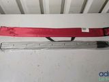 a red tie and a ruler on a white table