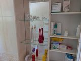 a medicine cabinet in the corner of the bathroom