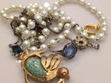 une photo d'un collier orné d'un oiseau et de perles