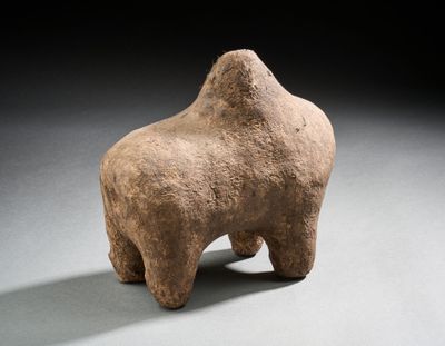 an image of a sculpture of a bull on a gray surface