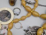 a lot of jewelry that is laying out on the table