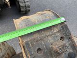 someone is measuring the height of a piece of wood with a ruler