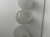 three empty plastic cups sitting on a white surface