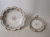 two pieces of porcelain dishes are sitting on a white surface