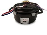 a close up of a black pot with a red, white and blue ribbon on it