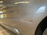 a close up of a car ' s side door with a reflection on it