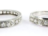 two wedding bands with diamonds on them on a white surface