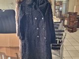 a coat on a mannequin stand in a room