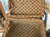 an old wooden box with a pattern on it sitting on top of a table