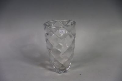 un vase en verre transparent posé sur une surface blanche
