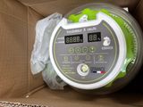 a box with a green and white electronic device inside of it