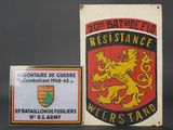 two metal signs and a plaque of a lion on a black background