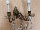 a wall sconce that has two candles on it