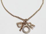 gold plated necklace with a charm and a letter o on a chain