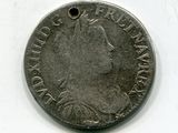une vieille pièce d'argent sur laquelle est représenté le visage d'une femme