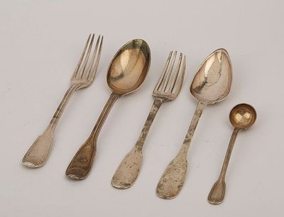 five spoons, forks and a spoon rest on a white surface