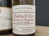 two bottles of wine that are sitting on a table