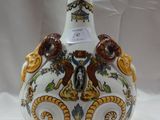un vase blanc orné de motifs jaunes et marron