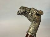 a close up of a walking stick with a dog on it