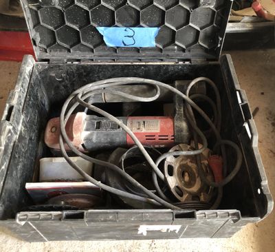 a tool box with tools in it sitting on the floor