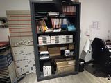 a room with a desk, a chair, and a bookcase