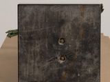 a small square metal object sitting on top of a table