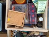 a wooden box filled with assorted items on the floor