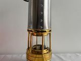 a silver and gold lantern that is on a table