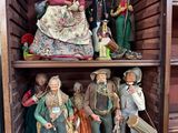 many figurines on a shelf in the corner of a room