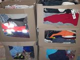 boxes of clothing are stacked on top of each other in a warehouse