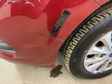 a close up of a red car with a sticker on it