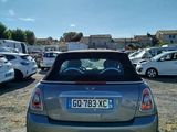 a small car parked in a parking lot with other cars in the background