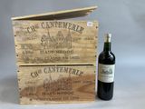 a bottle of wine sitting next to a wooden box