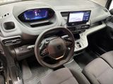the interior of a small car with a steering wheel and dashboard