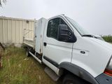 a white truck that is parked in the grass