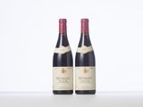 two bottles of red wine sitting next to each other on a table