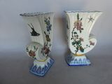 two vases sitting side by side on a table