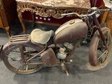 an old motorcycle that is sitting in a room