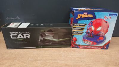 a box of spider - man remote control car next to a box of remote control car