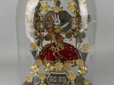 a glass dome with a clock inside of it