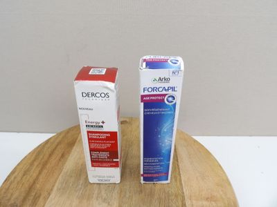 two tubes of toothpaste sitting on a cutting board