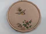 a picture of a decorative plate with a bird and flowers on it