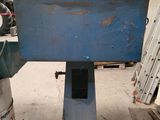 an image of a machine that is working on a piece of metal