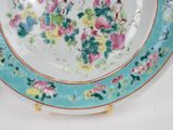 a plate with flowers and birds painted on it