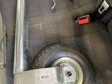 a wheel that is sitting in the back seat of a car