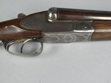 a close up of a gun on a table with a white background