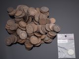 a pile of coins sitting on a table next to a bag of coins