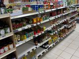 many shelves in the store that are full of food