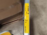 a yellow label on the side of a metal bar