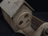 a wooden birdhouse with a bird inside of it